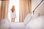 Healthy Woman Stretching In Bed Room And Open The Curtains After Stock Photo