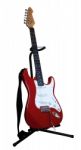 Red Electric Guitar On A Stand Stock Photo