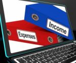 Income And Expenses Files On Laptop Shows Budgeting Stock Photo