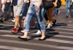 Feet Of Pedestrians Walking On The Crosswalk Stock Photo
