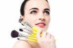Beautiful Teen Girl Holding Makeup Brushes Stock Photo