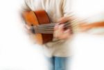 Zoom Blur Guitar Player Stock Photo