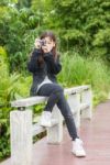 Asian Young Girl Taking Photos Outdoors Stock Photo
