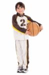 Young Kid In His Sports Dress With Basketball Stock Photo