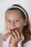 Little Girl Eating Apple Stock Photo
