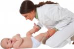 Happy Female Pediatrician Playing With Baby Boy Stock Photo