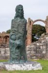 Statue Amid The Ruins Of Lindisfarne Priory Stock Photo
