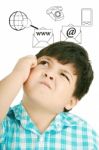 Young Thoughtful Child With Icons Stock Photo
