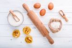 Ingredients For Homemade Pasta  Flour And Eggs On Wooden Backgro Stock Photo