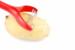 Peeling A Potato With Peeler On White Stock Photo