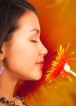 Young Girl Smelling Flower Stock Photo