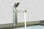 Water Flow Faucet Granite Counter On Cement Wall Stock Photo