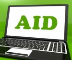 Aid On Laptop Shows Assisting Aiding Help Or Relief Stock Photo