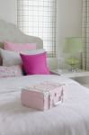 Girl's Bedroom With Pink Box On Green Bed Stock Photo