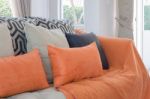 Orange Pillows And Blanket On Modern Sofa In Living Room Stock Photo