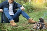 Man Overroast Their Marshmallow Candies On The Campfire On Campi Stock Photo