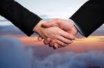 Business Handshake On A Sky Background Stock Photo