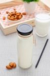 Almond Milk In Glass Bottle With Almonds Stock Photo