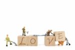 Miniature Worker Team Building Word Love On White Background Stock Photo
