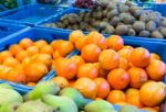 Various Fruit In Blue Crates On Market Stock Photo