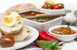 Slices Of Bread And Butter With Tomatoes, Peppers, Chutney And P Stock Photo