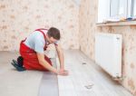 Handyman Laying Down Laminate Flooring Boards Stock Photo