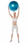 Sporty Lady Holding Ball Over Head Stock Photo