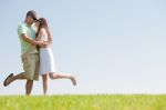 Young Couple Fooling Around On The Park Stock Photo