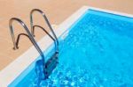 Blue Swimming Pool With Ladder Stock Photo