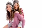 Young Girl Giving Piggyback To Her Friend Stock Photo