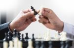 Confident Businessman Colleagues Playing Chess With Colleague To Stock Photo