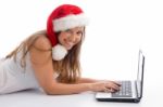 Laying Female With Christmas Hat And Laptop Stock Photo