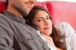 Loving Young Woman With Boyfriend Relaxing On Sofa Stock Photo