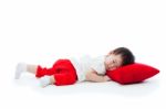 Little Girl Lying On Red Pillow Stock Photo