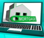 Mortgage House Laptop Shows Owing Money For Property Stock Photo