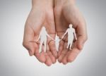 Paper Cut Of Family On Hand Stock Photo