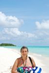 Beautiful Senior Woman Walking On A Tropical Beach Stock Photo