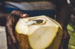 Man Holding An Open Coconut Stock Photo