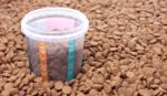 Dry Brown Pet Food (dog Or Cat) With Measure Glass Stock Photo