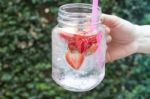 Hand Hold Glass Of Iced Strawberry Soda Drink Stock Photo