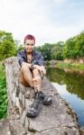 Punk Girl Sitting On The Dike Stock Photo
