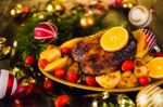 Christmas Baked Duck Served With Potatoes, Orange And Tomatoes Stock Photo
