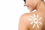 Woman With Sun Block Cream On Her Back Stock Photo