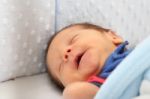 Newborn Smiling In His Dream Stock Photo