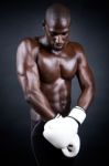 Young Athletic Boxer Wearing Gloves In Black Background Stock Photo