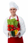 Male Chef Holding Glass Bowl Full Of Vegetables Stock Photo