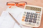 Work Station With Calculator, Pen And Eyeglasses Stock Photo