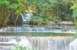 The Water Flowing Over Rocks And Trees Down A Waterfall At Huay Mae Khamin Waterfall National Park ,kanchana Buri In Thailand Stock Photo