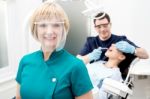 Male Dentist With Patient, In Clinic Stock Photo