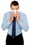 Young Man Having Severe Cold. Sneezing Stock Photo